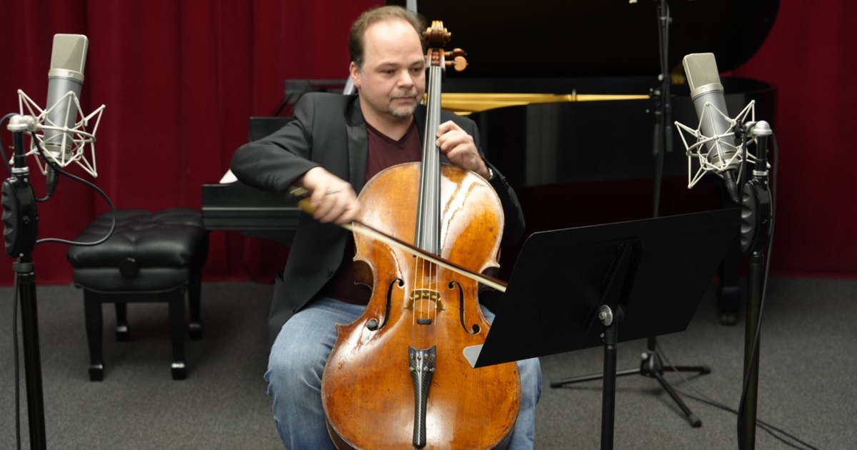 Cellist Laszlo Mezo performing in a professional recording studio