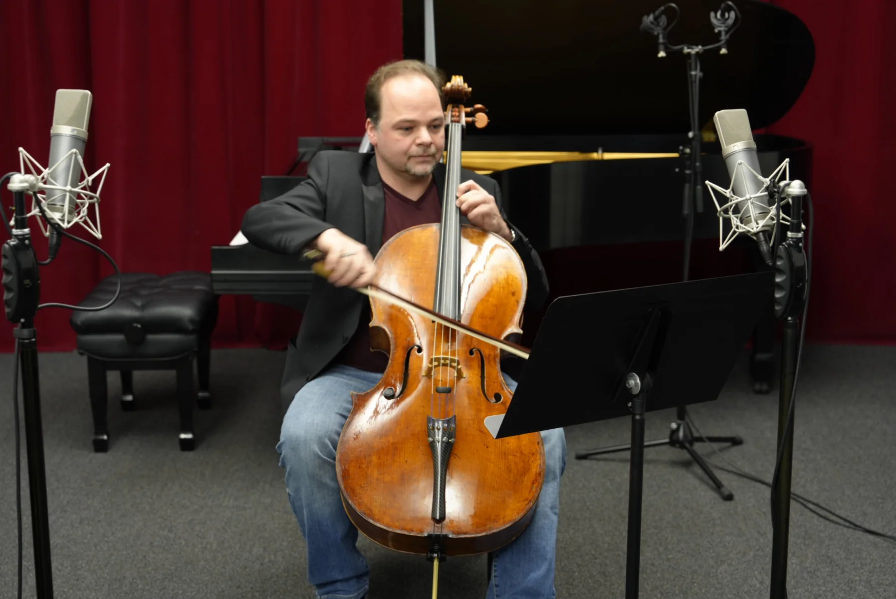 Laszlo Mezo performing cello in a professional recording studio