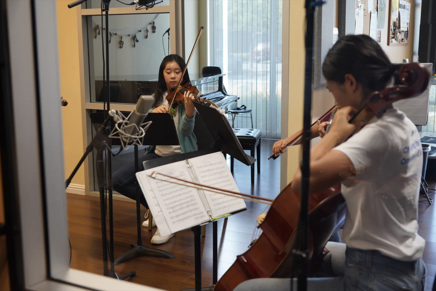 Students rehearsing chamber music with cello and violin in the studio