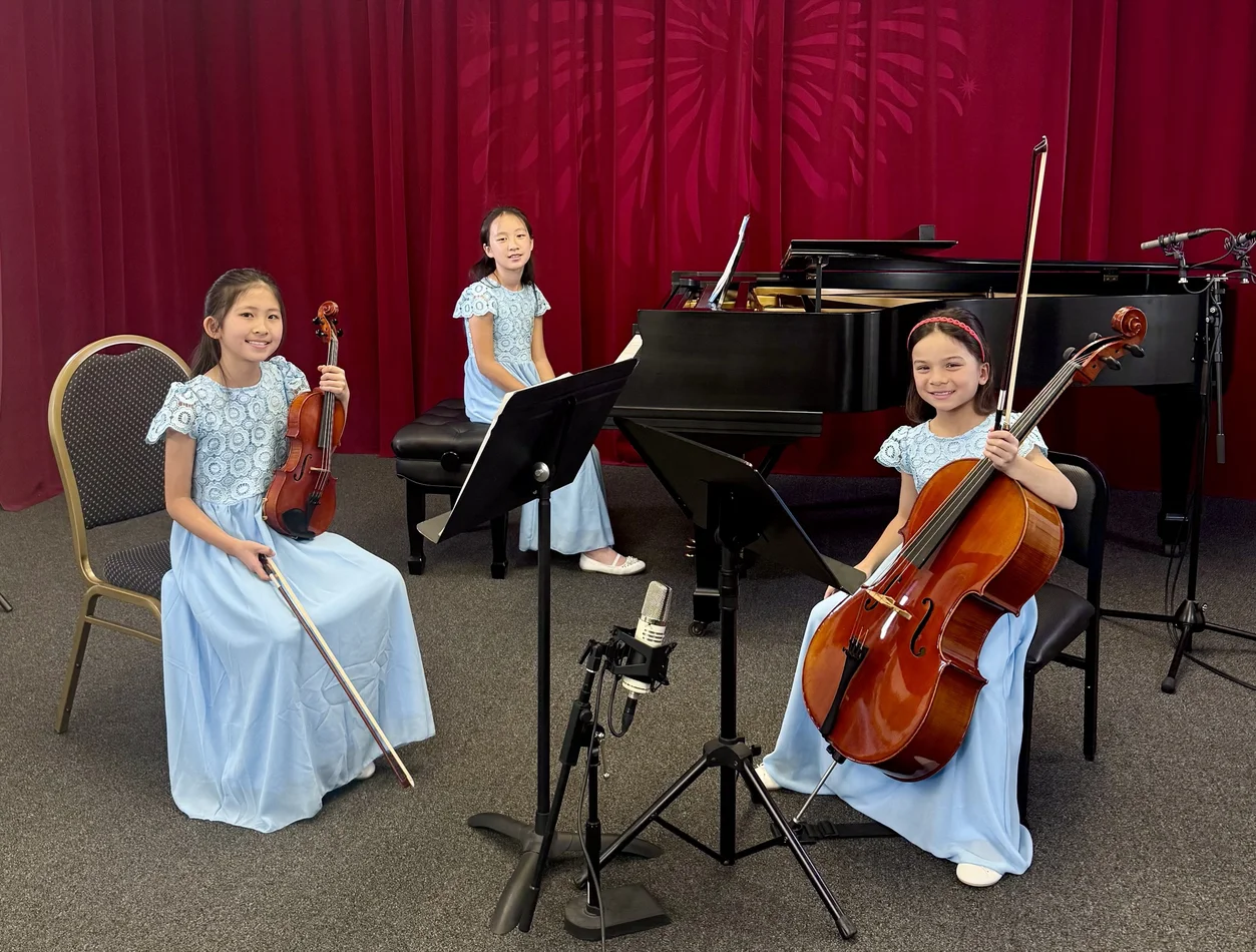 Student recital group with cello, violin, piano, and recording microphones